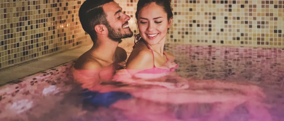 A couple laughing in a hot tub