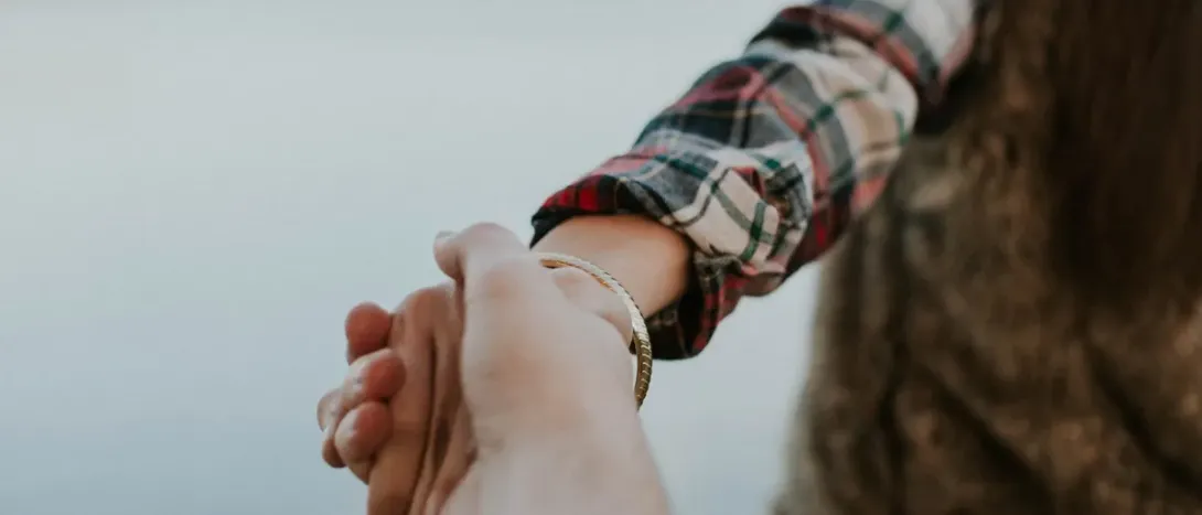 One hand leading another by the wrist