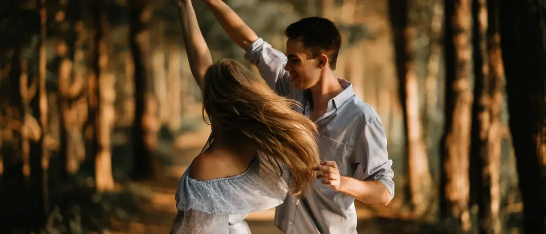 A couple dancing in a forest